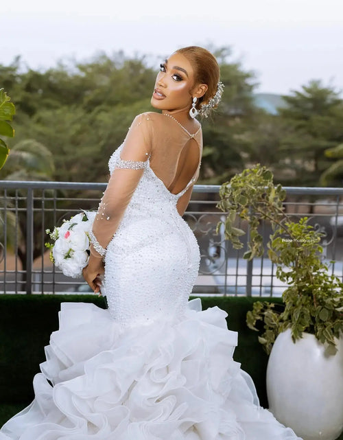 Load image into Gallery viewer, Charming Shiny Pearl &amp; Bead Mermaid Wedding Dress – Long Sleeves, Cascading Ruffles &amp; Open Back Bridal Gown
