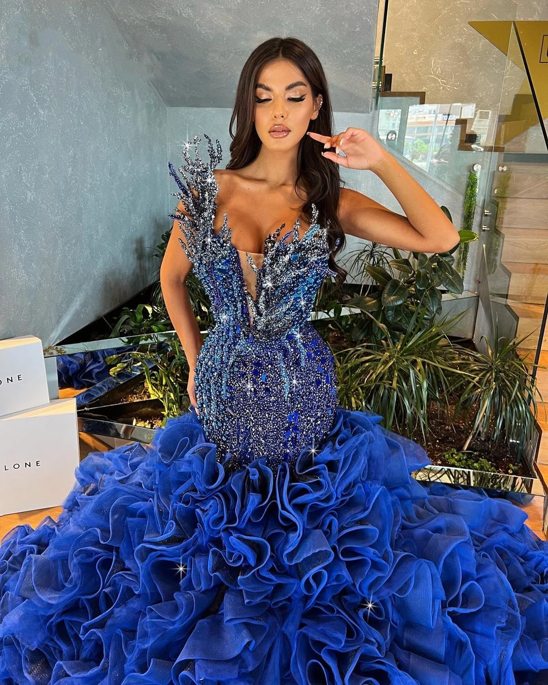 Luxurious Blue Strapless Prom Dress with Pearls, Crystal Beading, and Tiered Ruffle Train